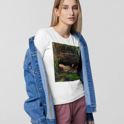A young woman wearing a white t-shirt with a graphic design, a denim jacket, and pink pants stands against a plain background.
