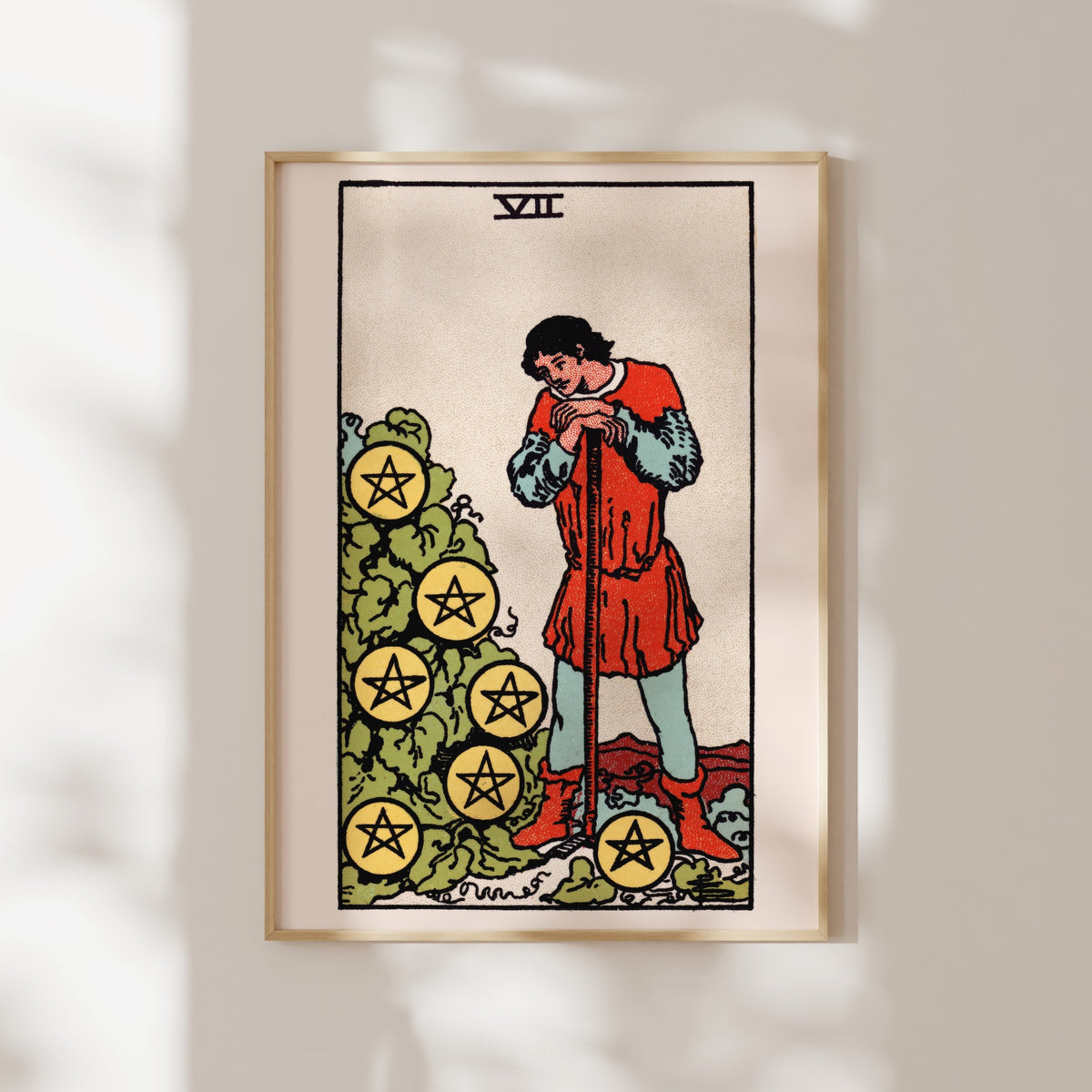 The image is a framed tarot card depicting a man standing in front of a pile of yellow stars.