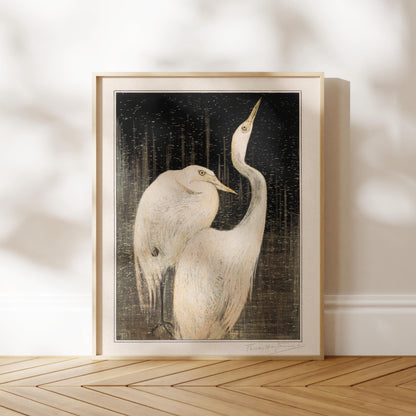 a framed painting of two white birds standing together on a wooden floor.