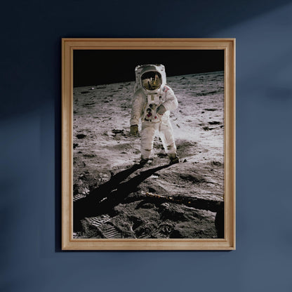 an astronaut in a white spacesuit standing on the surface of the moon, with a dark background.