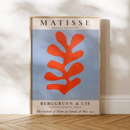 a poster for the exhibition "MATISSSE" by the artist Jean-Michel Basquiat, which took place in Berggruen, Paris from 28 to 29 March 1973. The poster showcases a large abstract leaf-like shape in red and blue colors.