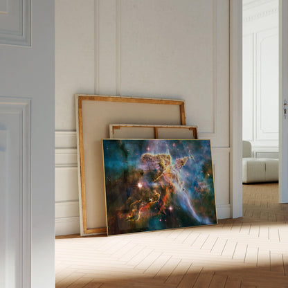 a large, colorful painting of a nebula, which is a vast cloud of gas and dust in outer space. The painting is displayed on a wooden floor in a room with white walls.