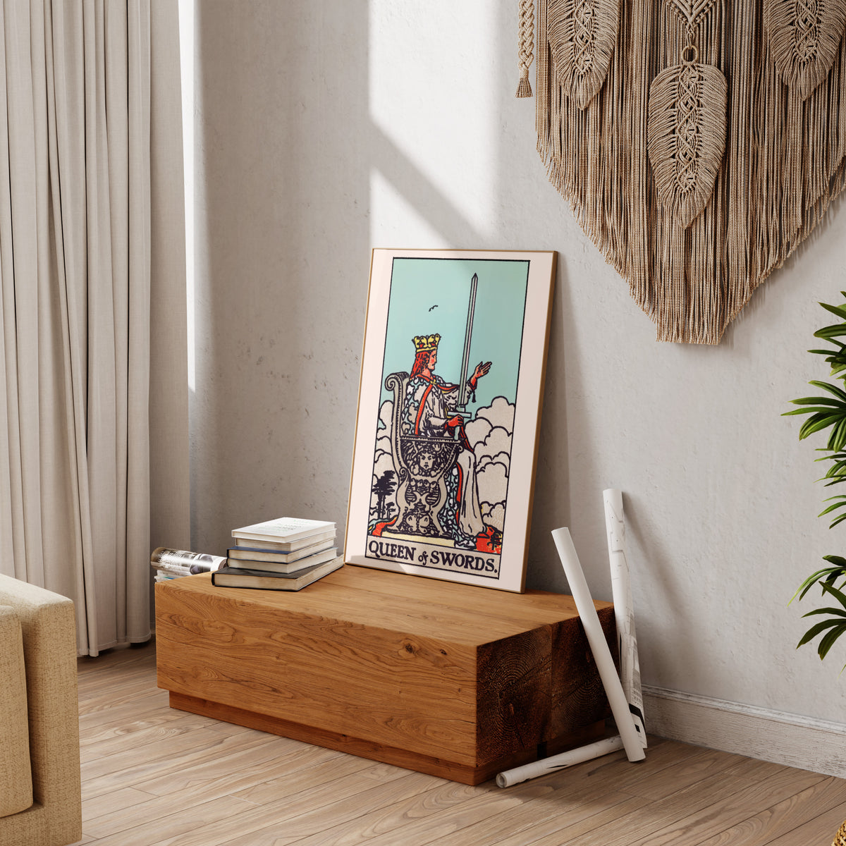 a wooden table with a framed tarot card, a stack of books, and a woven wall hanging.