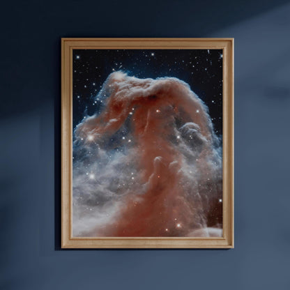 The image is a framed photograph of a nebula, a vast cloud of gas and dust in space, against a dark blue background.