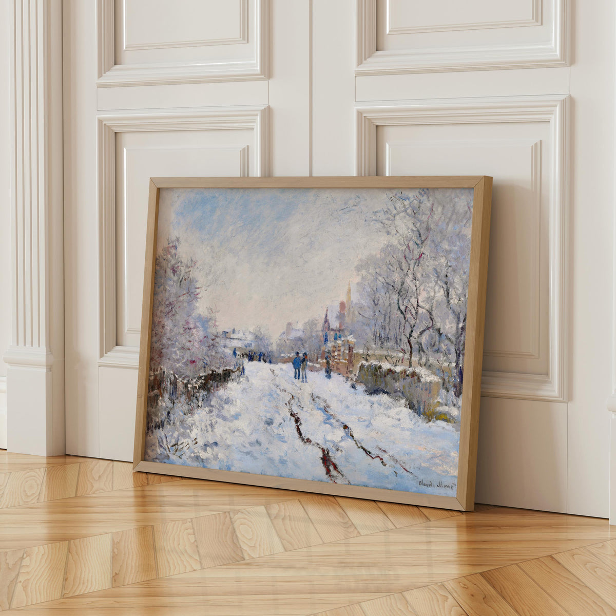 A framed painting depicting a snowy winter landscape with people walking along a path through the snow-covered trees.