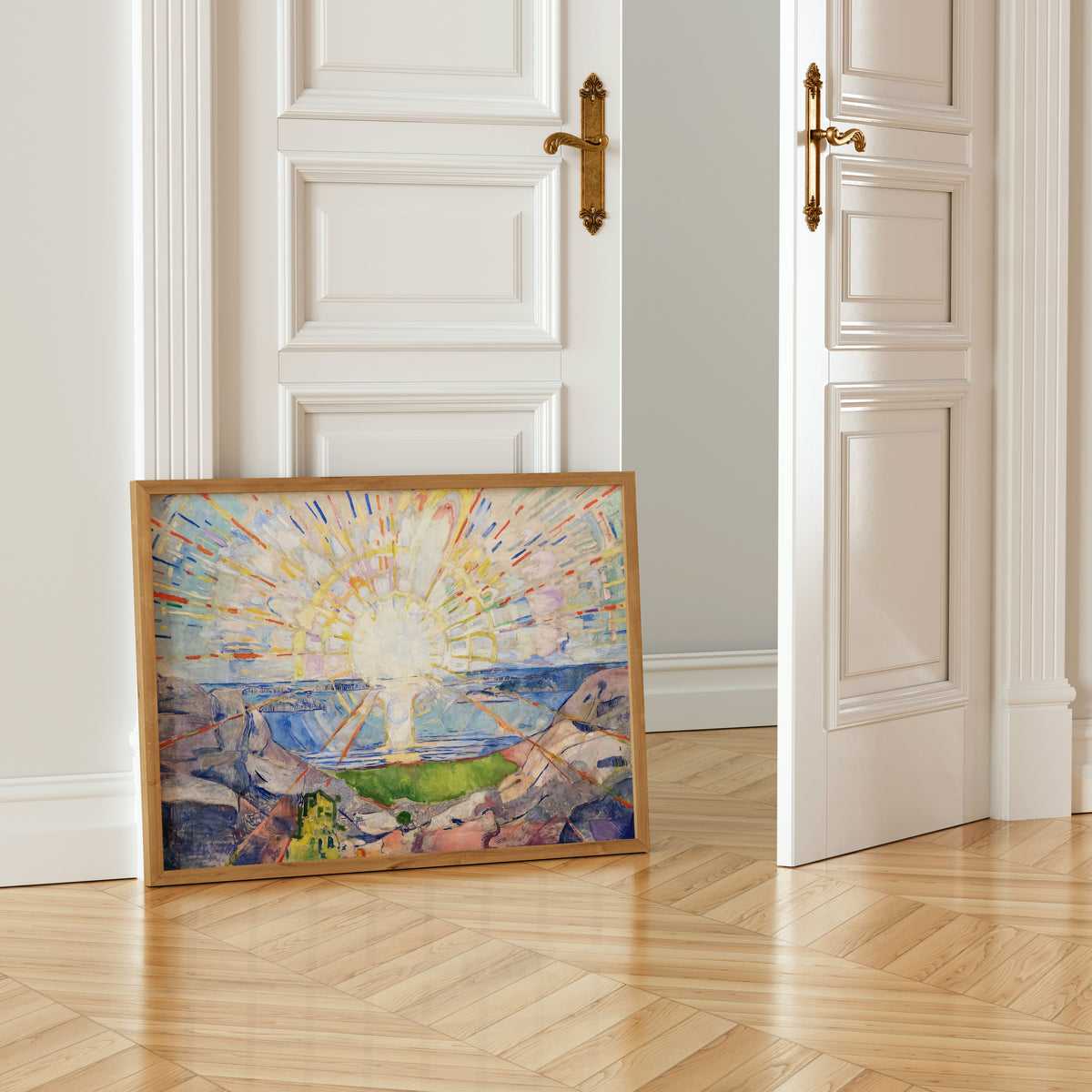 a painting of a landscape with a sunburst effect, placed on a wooden floor in front of an open white door.