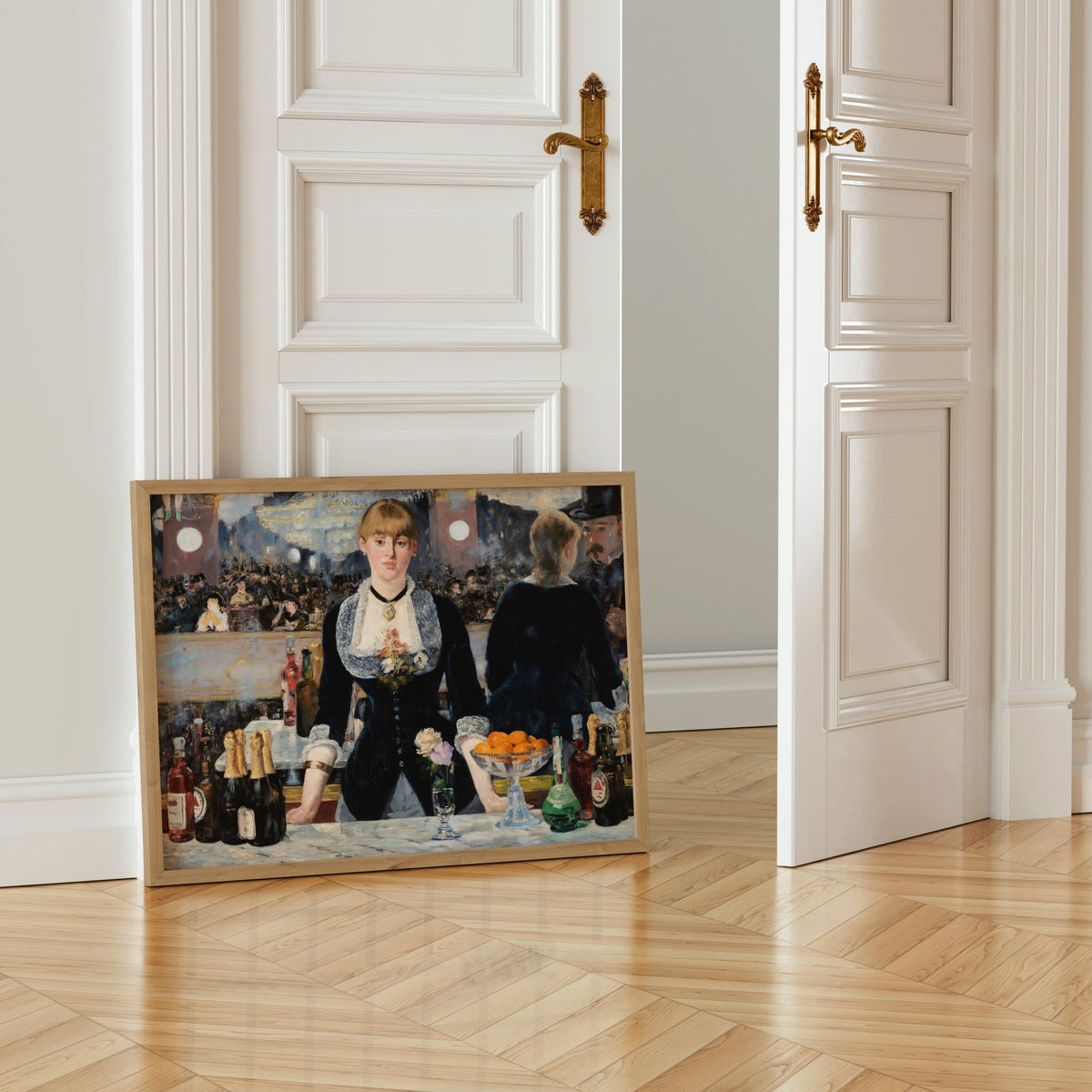 A framed painting of a woman in a black dress standing behind a bar, surrounded by various bottles of alcohol, is displayed on a wooden floor in a room with white walls.