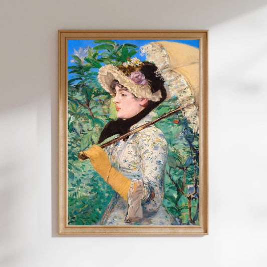 A framed painting depicting a woman wearing a hat and holding an umbrella, standing in a garden setting with lush greenery in the background.