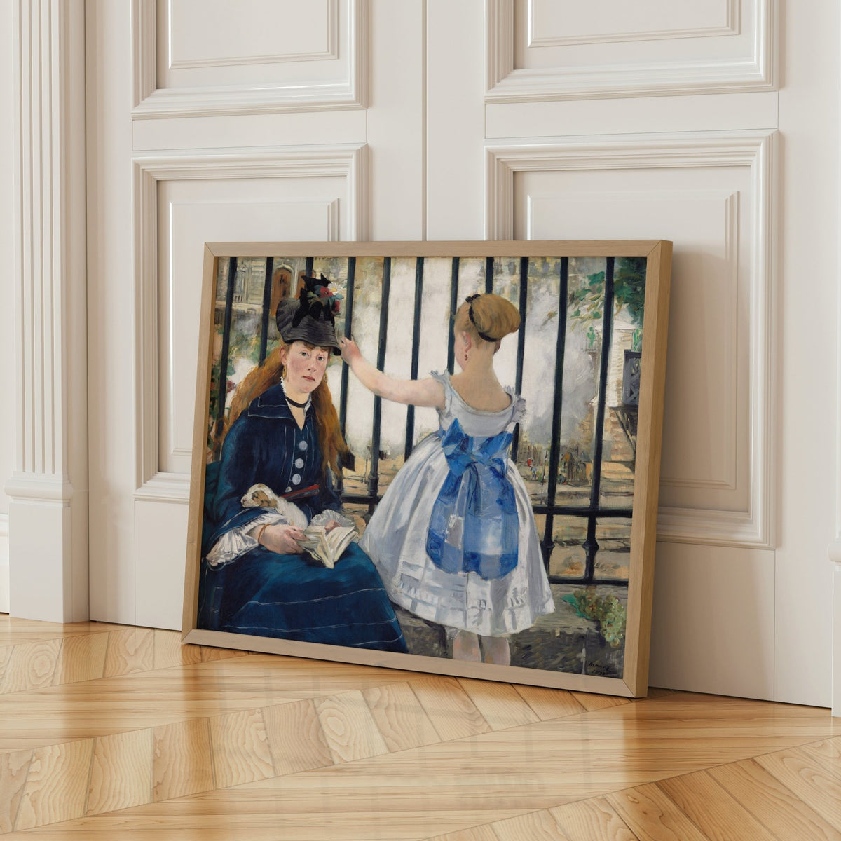 A framed painting depicting two women, one wearing a blue dress and the other in a black dress, sitting together and engaged in conversation.
