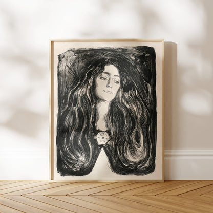 a framed black and white portrait of a woman with long, flowing hair.