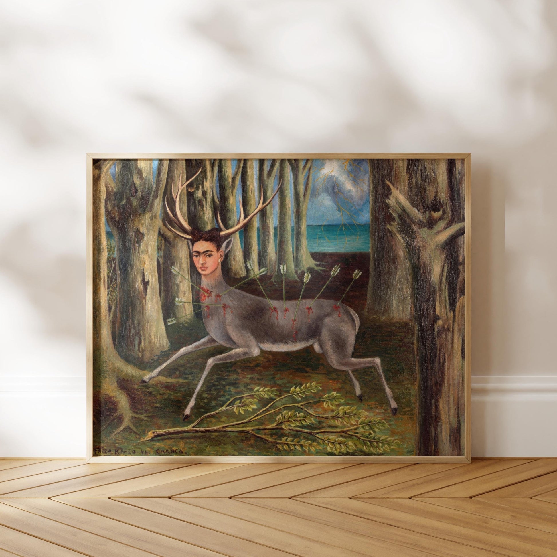 The image is a framed painting depicting a deer with antlers standing in a forest setting.