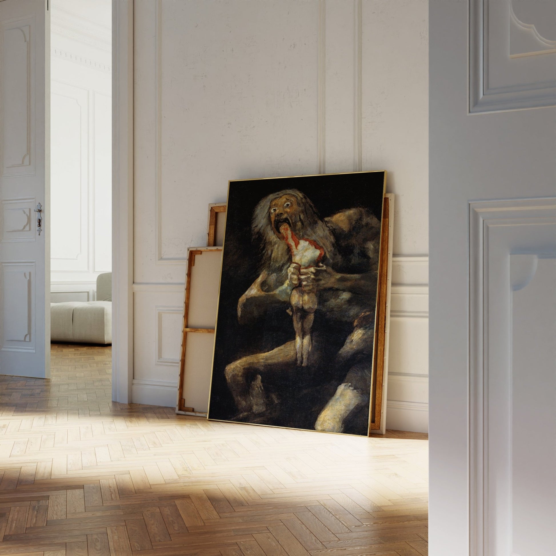a large painting of a lion with a human figure in its mouth, displayed on a white wall in a room with a wooden floor.