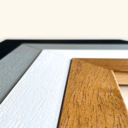 a close-up view of a wooden surface with a textured, natural grain pattern. The wooden surface is positioned next to a white surface, creating a contrast between the two materials.