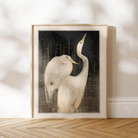 a framed painting of two white birds standing together on a wooden floor.